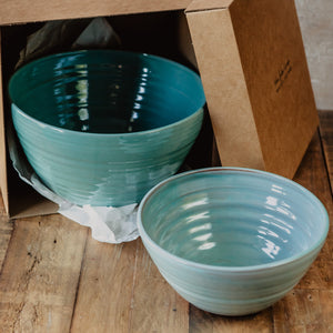 Large turquoise bowl in a brown gift box and a smaller turquoise bowl in front