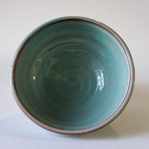 Mini turquoise bowl from above on a white background